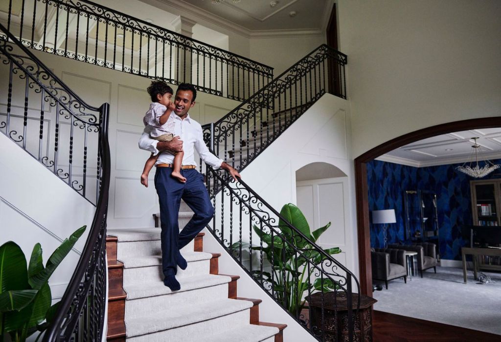 Ramaswamy carries his son Karthik at their home in Columbus, Ohio