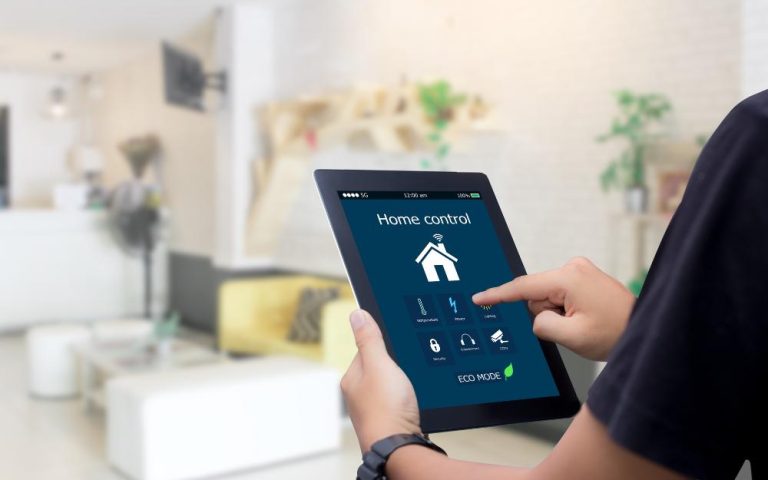 A person using a tablet to control smart home features in a modern living room.