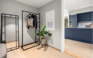 A living room with a couch and a coat rack