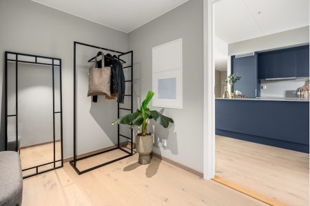 A living room with a couch and a coat rack