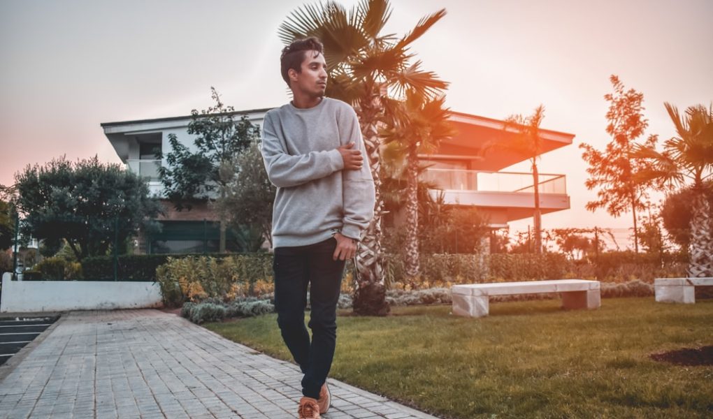 man walking on pathway during golden hour