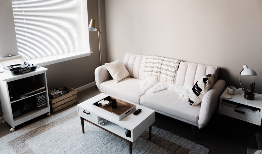 white couch in front of white wooden table