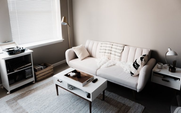 white couch in front of white wooden table