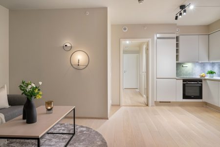 A living room filled with furniture and a kitchen