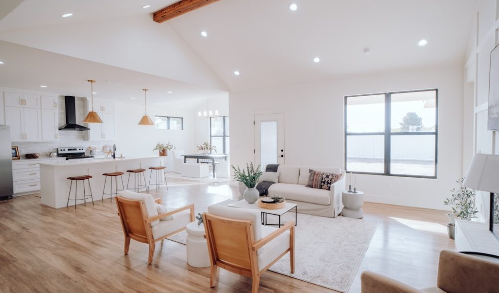 a living room filled with furniture and a kitchen