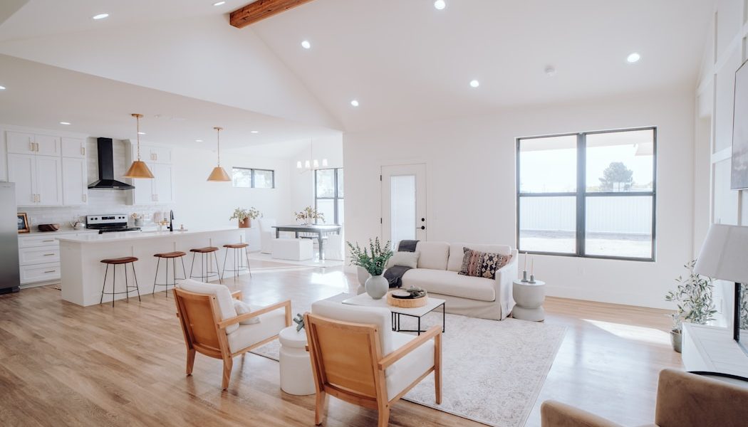 a living room filled with furniture and a kitchen