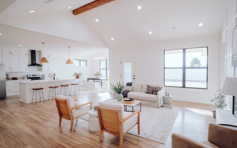 a living room filled with furniture and a kitchen