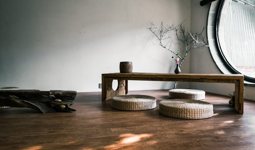 brown wooden bench near window