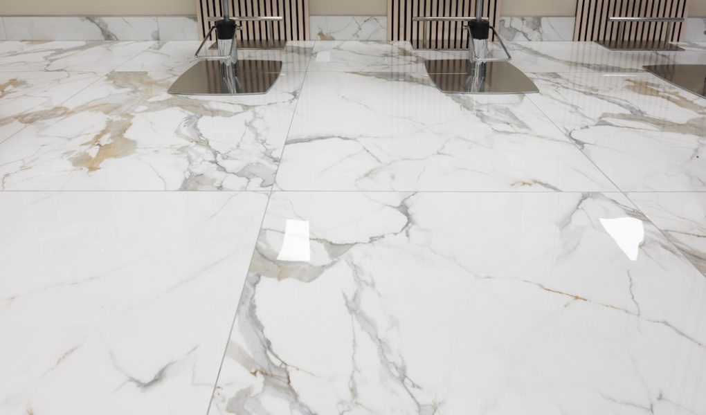 three chairs sitting on a marble floor in a room