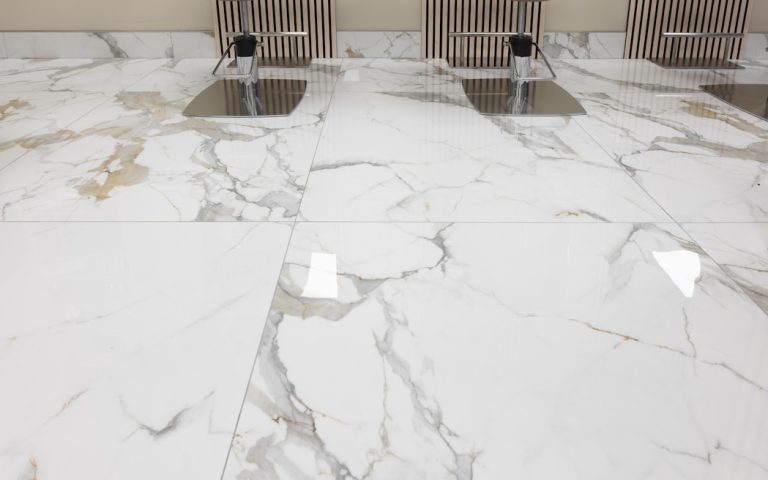 three chairs sitting on a marble floor in a room