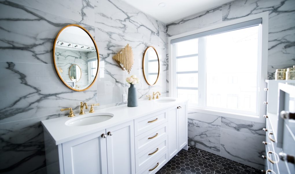 a bathroom with two sinks and a large mirror