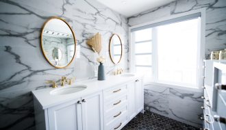 a bathroom with two sinks and a large mirror