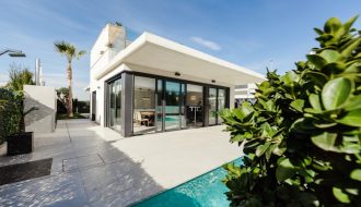 white and grey concrete building near swimming pool under clear sky during daytime