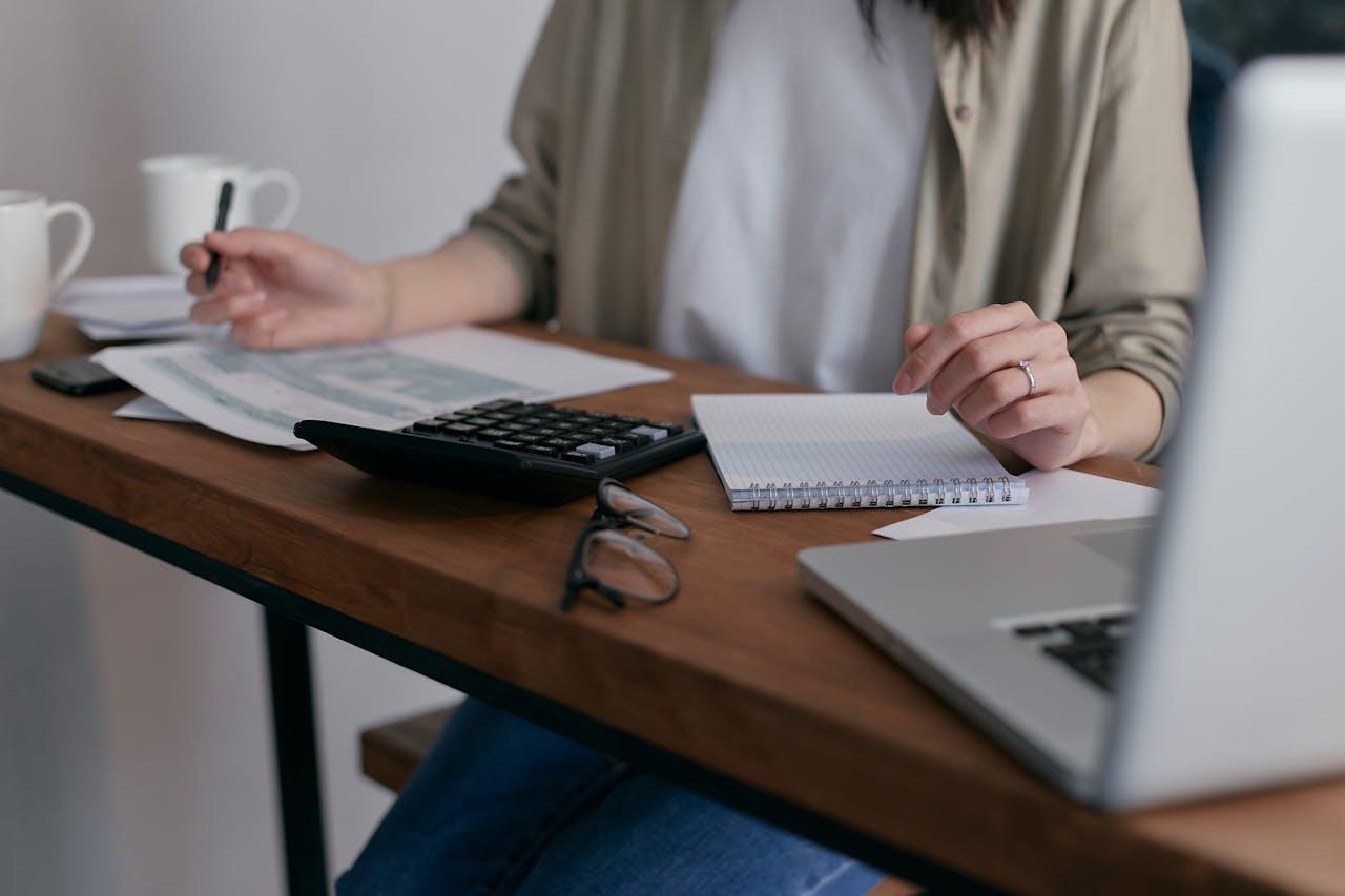 A woman sitting at her desk while holding a pencil
