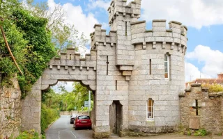 Manderley Castle exterior view with turret overlooking Killiney Bay.