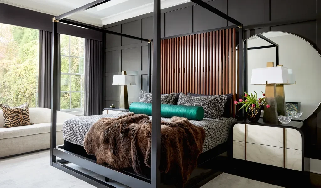 Modern gray and white master bedroom featuring layered linen bedding and a charcoal accent wall