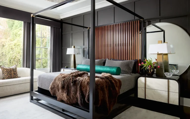 Modern gray and white master bedroom featuring layered linen bedding and a charcoal accent wall
