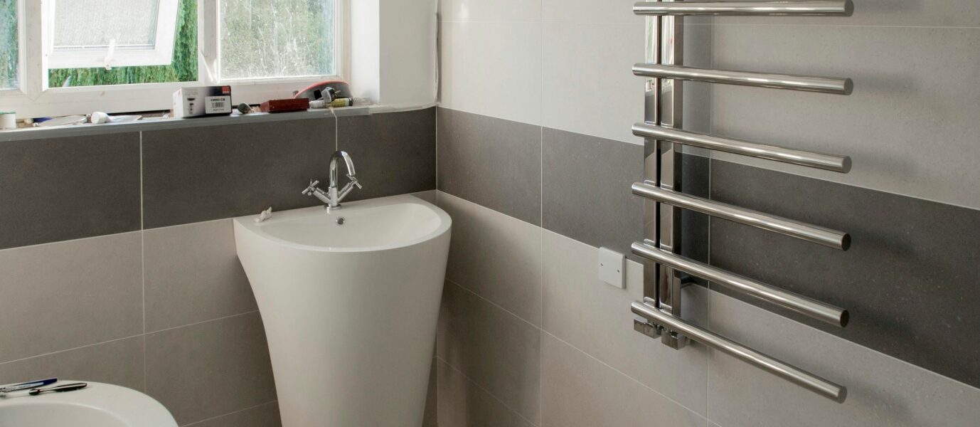 A white bath tub sitting next to a window