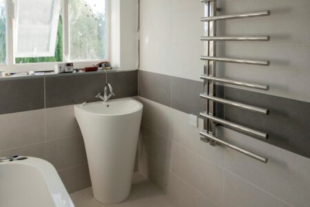 A white bath tub sitting next to a window