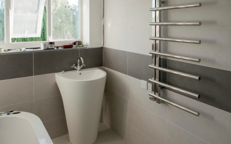 A white bath tub sitting next to a window